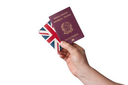 Man hold a european union italian passport and a united kingdom flag wallet on white background