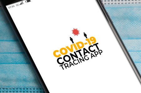 Smartphone running a Covid.19 contact tracing app over a surgical mask