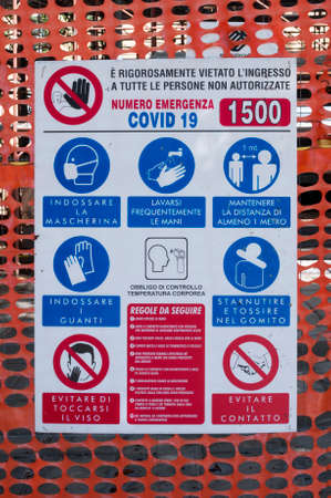 Carrara, Italy - June 17, 2020 - Covid-19 rules at the entrance of a construction site in Italyのeditorial素材