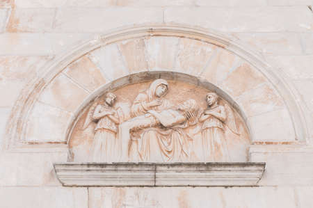 Bas-relief depicting the deposition of Jesus on the facade of the cathedral of Pietrasanta.の写真素材