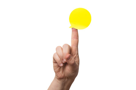 Hand with a speech bubble shaped sticky note on the tip of the first finger