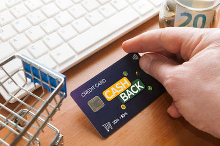 Cashback concept: man do online shopping with a cashback credit cardの写真素材