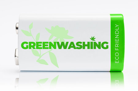 9 volt green and white battery with the word Greenwashing printed on it. Greenwashing is a communication technique aimed at building a false image of a company in terms of environmental impact.の写真素材