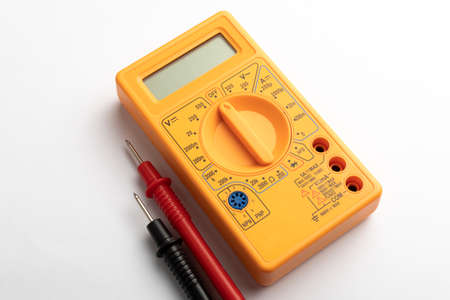 Yellow digital multimeter with probes on white backgroundの写真素材