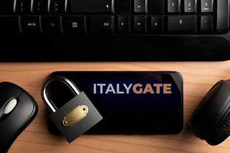 Italygate concept: smartphone on wooden table with a mouse a computer keyboard and a pair of...