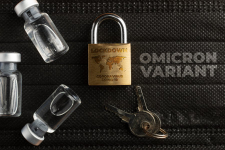 Omicron variant concept: a lock over a black surgical mask and some vials.