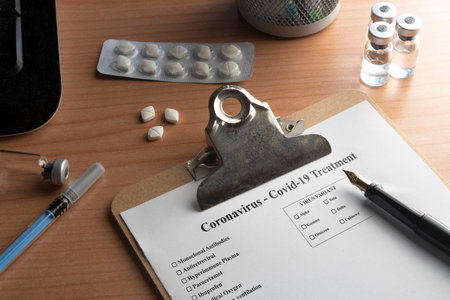 Medical record for coronavirus covid-19 on a desk with pills vials and a syringe