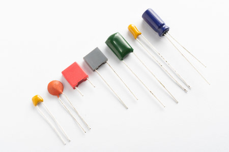 Different types of ceramic, film, tantalum and electrolytic capacitors on white background