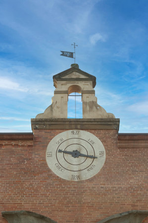 Pisa, Italy - April 10, 2022 - Ancient wind vane on the facade of the Sinopie Museum in Pisa