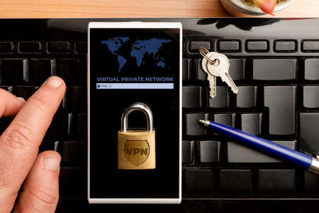 VPN (virtual private network) concept, man using a vpn software on a smartphoneの写真素材