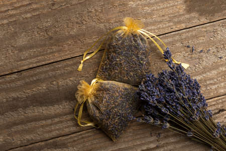 Organza bags filled with lavender on wooden floorの写真素材