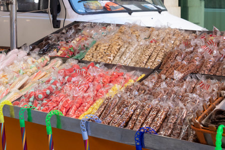 Candies, nuts and caramelised dried fruit at a street marketの写真素材