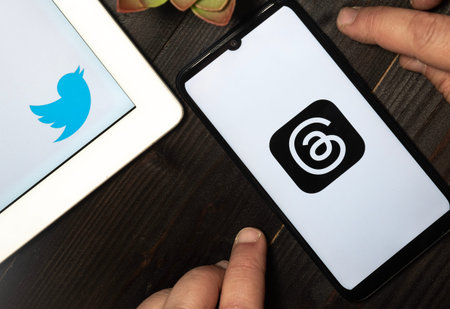 Carrara, Italy - July 6, 2023 - Thread app logo and twitter logo on a smatphone and a tablet. Thread...