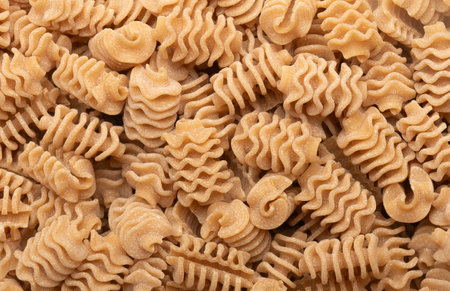 Background of Italian wholemeal radiatori type pastaの写真素材