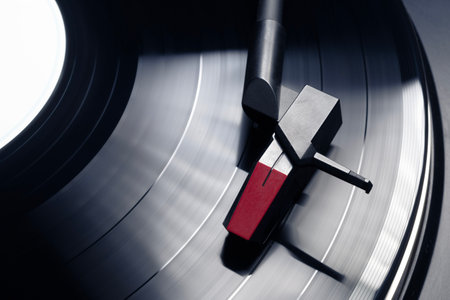 Turntable plays vinyl, high contrast and motion blurの写真素材