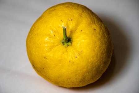 Ripe yellow tangerine on a white background close-upの写真素材