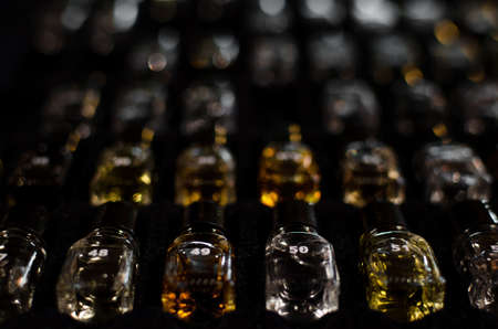 first line of bottles of a wine tasting aroma essence kit for professional sommeliers with out of focus backgroundの写真素材