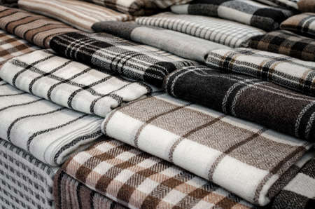 Cashmere wool scarves and wraps with lines and square decoration on a market stallの写真素材