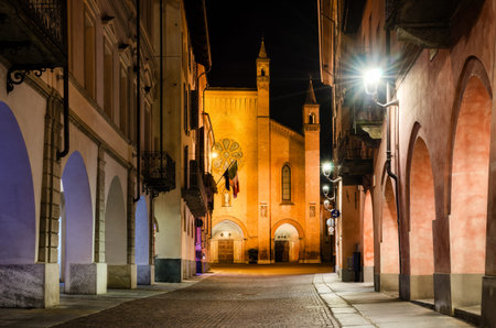 Piazza Risorgimento and via Cavour, main square of Alba (Piedmont, Italy) at night with the facade of Saint Lawrence cathedralの写真素材