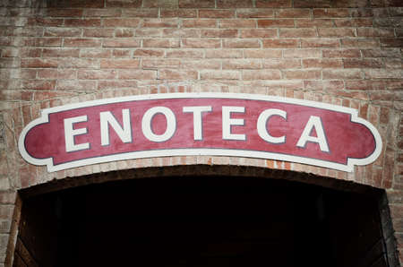 Old signboard of an italian "enoteca" (meaning "wine shop") in Piedmontの写真素材