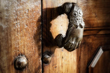 Antique hand shaped door knocker closeupの写真素材
