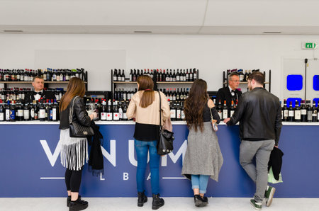 ALBA, ITALY - APRIL 22, 2017 - Sommelier, and tourists tasting Barbaresco and Nebbiolo, traditional...