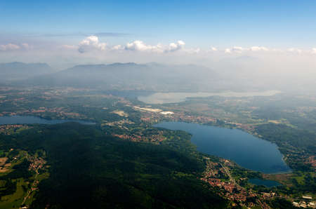 Alps, lakes, fields and towns neal Malpensa Airport (Milan, Italy) seen from an airplaneの写真素材