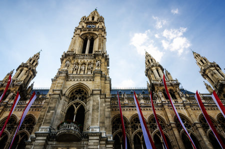 The Wiener Rathaus (Vienna City Hall, Austria) at sunset, with austrian flags over the facadeの写真素材