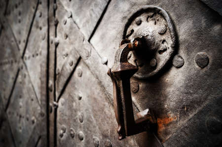 Antique iron knocker on a medieval castle doorの写真素材