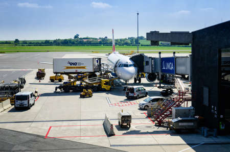 VIENNA, AUSTRIA - MAY 17, 2017: Austrian Airlines Airbus in Wien Flughafen Airport (Austria) on may 22, 2017. Loading operation with workers and vehiclesのeditorial素材