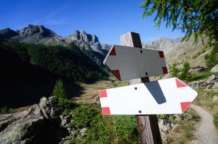 Mountain path signboard with blank trekking indication arrowsの写真素材