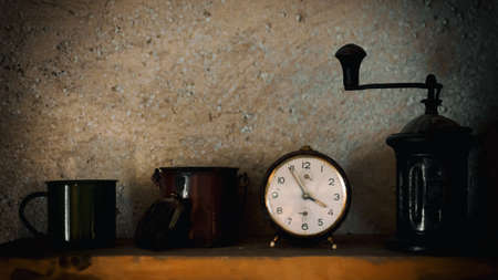 Vintage alarm clock on a shelf of an old house wall with mugs, a money purse and a coffee grinderの写真素材