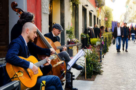 ALBA, ITALY - OCTOBER 7, 2017: Street band playng music and tourists walking in the center of Alba (Piedmont, Italy) on october 8, 2017, during the famous Fiera del Tartufo (International Truffle Fair)のeditorial素材