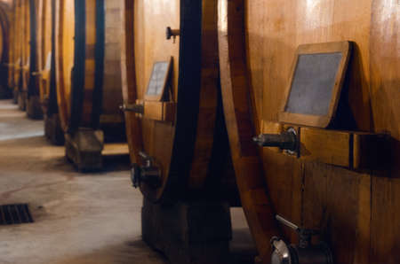 Historic cellar in Piedmont, Italy, with slavonian oak wooden barrels for the the aging of red winesの写真素材