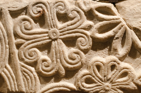 Romanesque decorations carved in the stone wall of an ancient medieval churchの写真素材