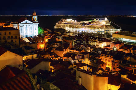 Night view of Lisbon (Portugal) cruise ships port from the miraduro of Santa Luzia, belvedere terrace over the streets of Alfama District, with the church of Santo Estevaoのeditorial素材