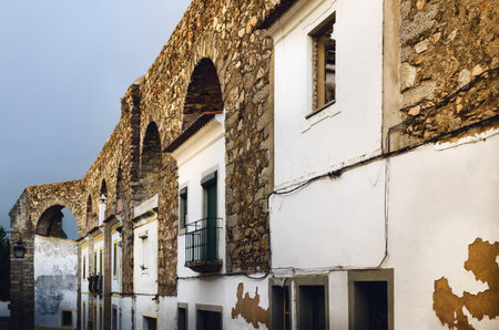Houses in Evora (Alentejo, Portugal) along the ancient Agua da Prata aqueduct. Buildings were built...