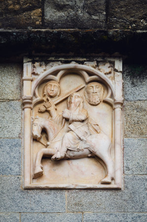 Gothic bas relief of a knight on the external wall of a medieval church