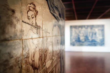LISBON, PORTUGAL - FEBRUARY 2, 2019: baroque XVIII century set of ancient azulejo, traditional painted tiles with female flute player in the Lisbon National Tile Museum, Portugal, on february 2, 2019のeditorial素材