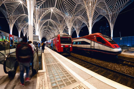 LISBON, PORTUGAL - FEBRUARY 4, 2019: Tre modern train station of gare do oriente in lisbon (portugal) build by santiago calatrava, at night with passengers and trains waiting, on february 4, 2019のeditorial素材