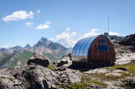 Exterior the longet pass olivero mountain bivouac (free sleeping shelter) in the piedmontese alps (Italy), facing the famous peak of Monviso (Mount Viso)のeditorial素材