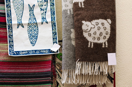 many traditional portuguese wool scarves and cotton cloth with sheeps and sardines decorations
