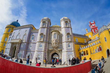 Sintra, Portugal - February 4, 2019: Exterior front view of the Pena Palace, famous colorful castle from the romantic age in Sintra, Portugal, on february 4, 2019, with people and touristsのeditorial素材