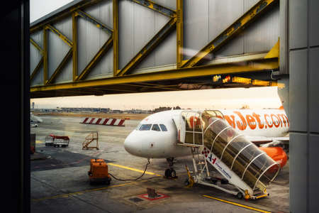Milan Italy - January 30, 2019: Easy Jet company airplane and boarding stairs, preparations before flight in Malpensa Airport (Milan, Italy) on january 30, 2019のeditorial素材