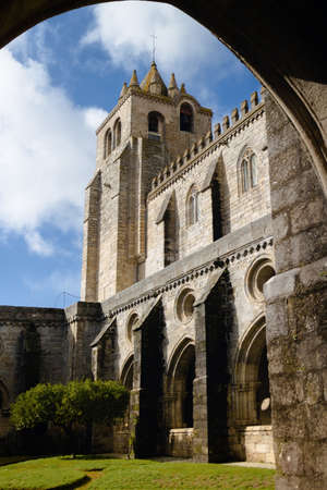 External view of the medieval gothic cloisters of the cathedral of Evora, main city of the Alentejo region (Portugal). Detail of the stone arches and bell tower from the courtyardのeditorial素材