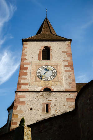 Detail of bell tower and cloch of the medieval church of Saint-Jacques-le-Major in Hunawihr, village between the vineyards of Ribeauville, Riquewihr and Colmar in Alsace, wine making region of Franceのeditorial素材