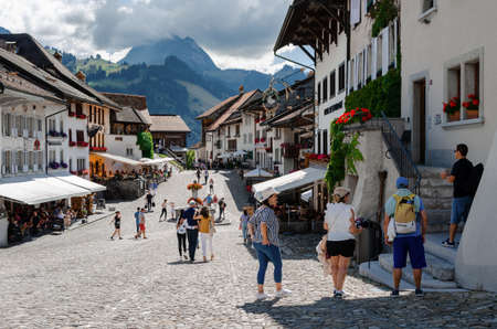 Gruyeres, Switzerland - July 11, 2020: Summer view of the swiss village of Gruyeres, on july 11, 2020, with the main street and many tourists walking in the town, between restaurants and shopsのeditorial素材