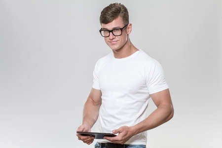 Handsome young man posing with tabletの写真素材