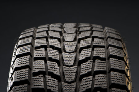 studio close-up detail of black winter tire
