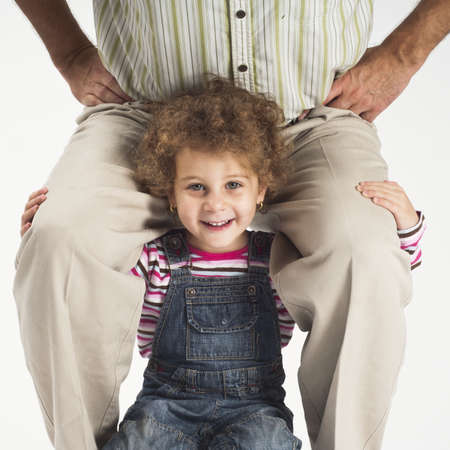 concept of overload,happy toddler girl holding father on shouldersの写真素材